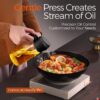 OilSync™ oil dispenser gentle sparying cooking oil into a plate of food