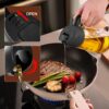 OilSync™ oil dispenser pouring cooking oil into a pan