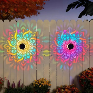 MandaGlow™ decorative solar mandala wall light projecting a colourful pattern onto an outdoor fence at night